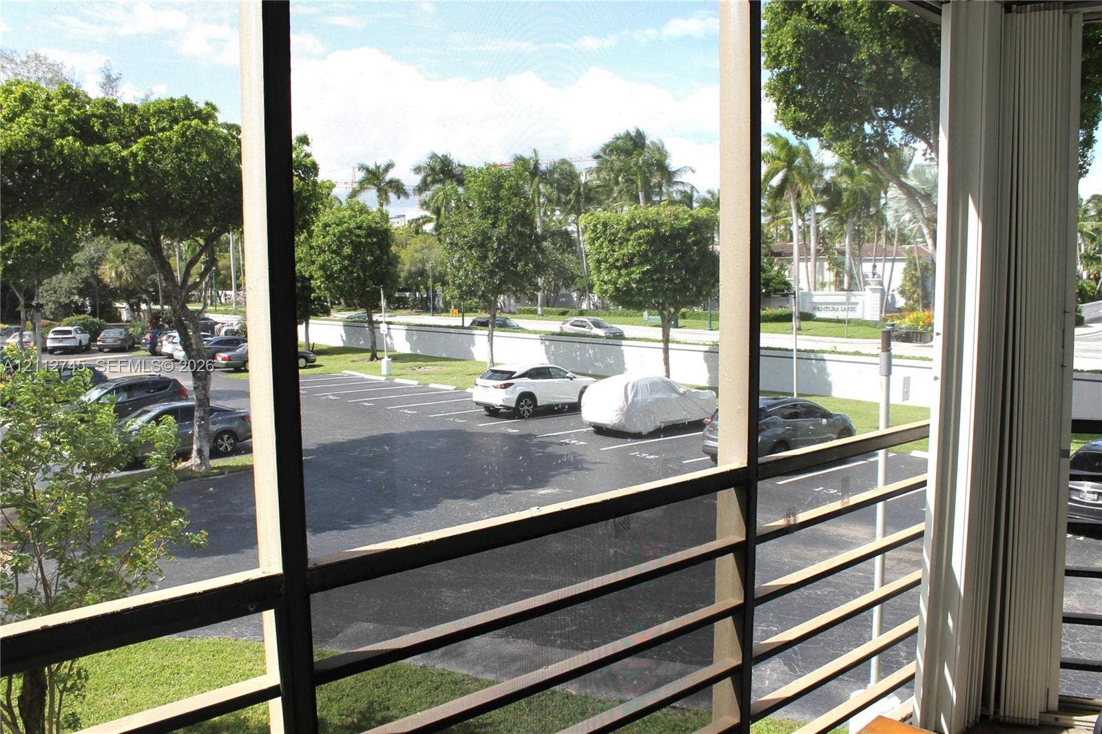20500 W Country Club Drive, #202, Aventura, FL 33180 Screened-in outdoor enclosure featuring horizontal metal slats and vertical sliding tracks