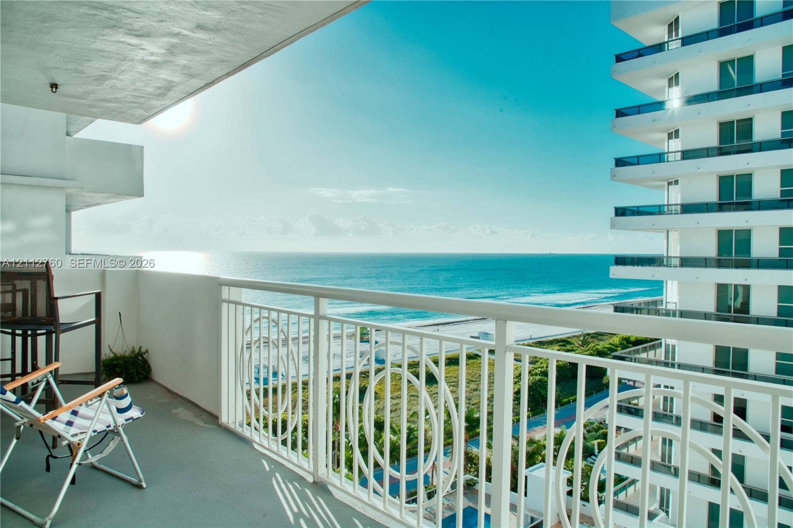5825 Collins Avenue, #11H, Miami Beach, FL 33140 Private balcony featuring white metal railings with decorative circular detailing and oceanfront exposure