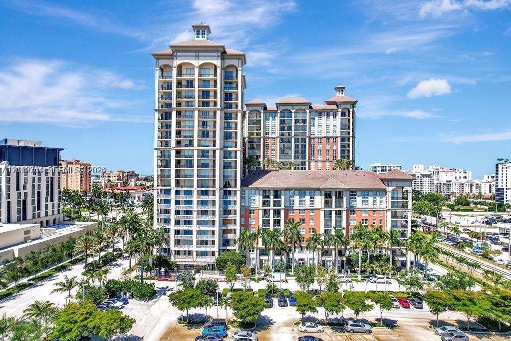 550 Okeechobee Boulevard, #224, West Palm Beach, West Palm Beach, FL 33401 High-rise residential exterior featuring multi-story masonry construction, arched architectural detailing, private balconies, and surrounding mature landscaping