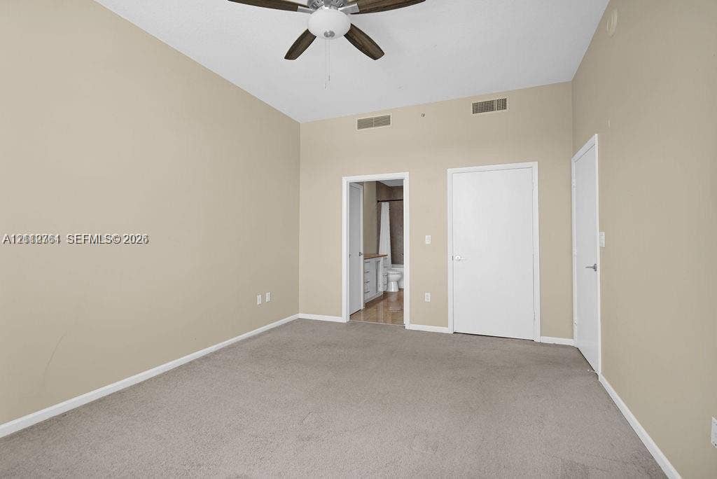 550 Okeechobee Boulevard, #224, West Palm Beach, West Palm Beach, FL 33401 Room featuring vaulted ceilings, neutral wall tones, wall-to-wall carpeting, and a ceiling fan with integrated lighting