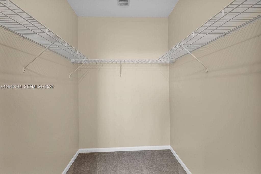 550 Okeechobee Boulevard, #224, West Palm Beach, West Palm Beach, FL 33401 Storage closet featuring neutral wall paint, gray carpeting, and white wire shelving