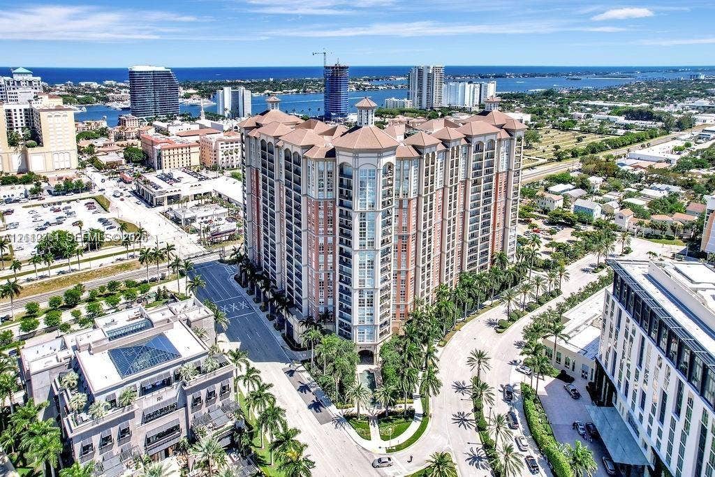 550 Okeechobee Boulevard, #224, West Palm Beach, West Palm Beach, FL 33401 High-rise multi-story building featuring a tile-hipped roof, articulated masonry facade, private recessed balconies, and integrated structural columns