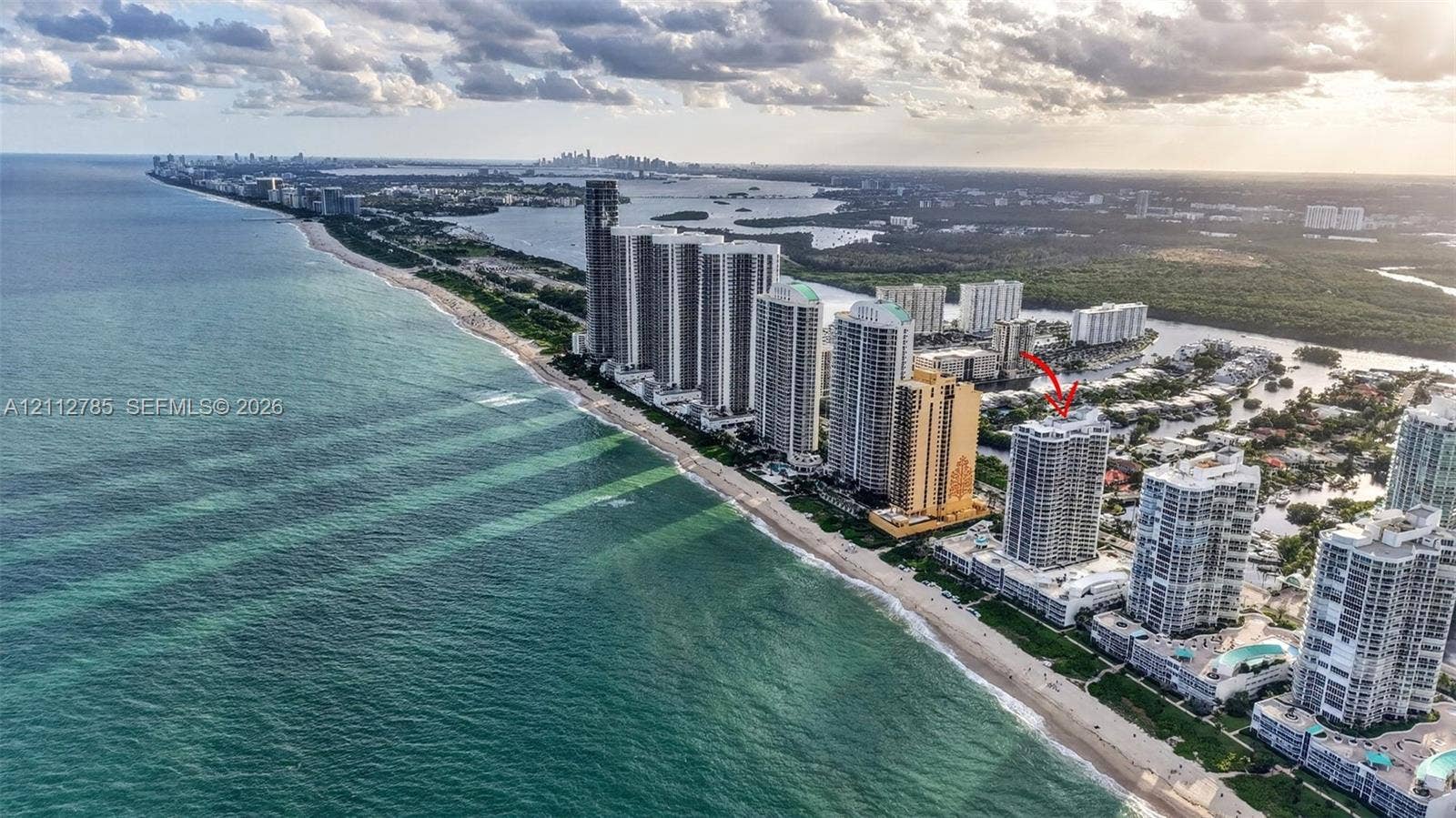 16425 Collins Avenue, #2016, Sunny Isles Beach, FL 33160 Aerial perspective featuring a high-rise residential building situated along a coastal shoreline with direct ocean frontage