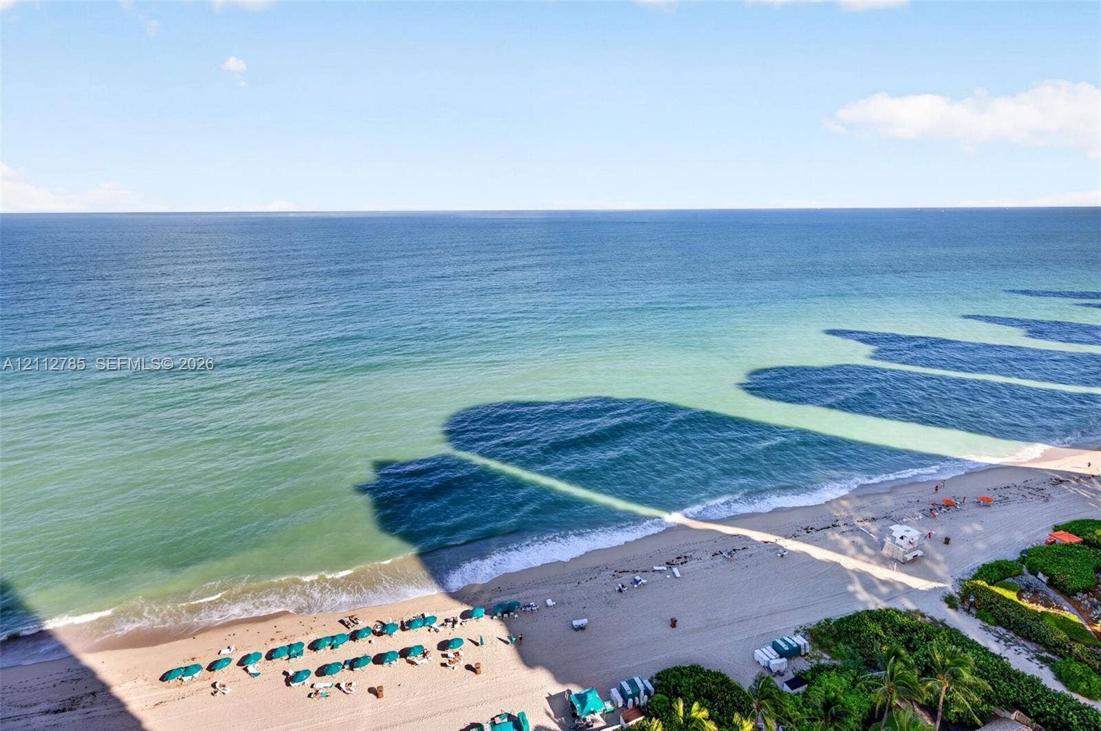 16425 Collins Avenue, #2016, Sunny Isles Beach, FL 33160 Oceanfront perspective featuring a wide stretch of sand, surf, and tropical vegetation