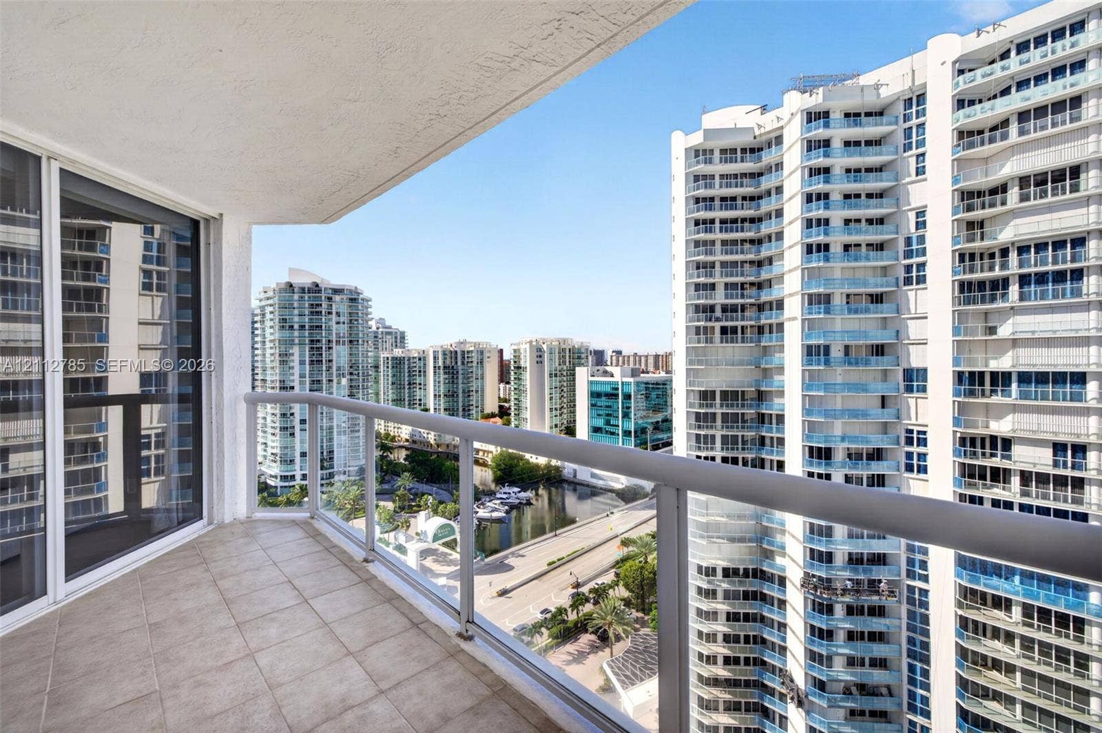 16425 Collins Avenue, #2016, Sunny Isles Beach, FL 33160 Covered balcony featuring tile flooring and a glass-paneled railing