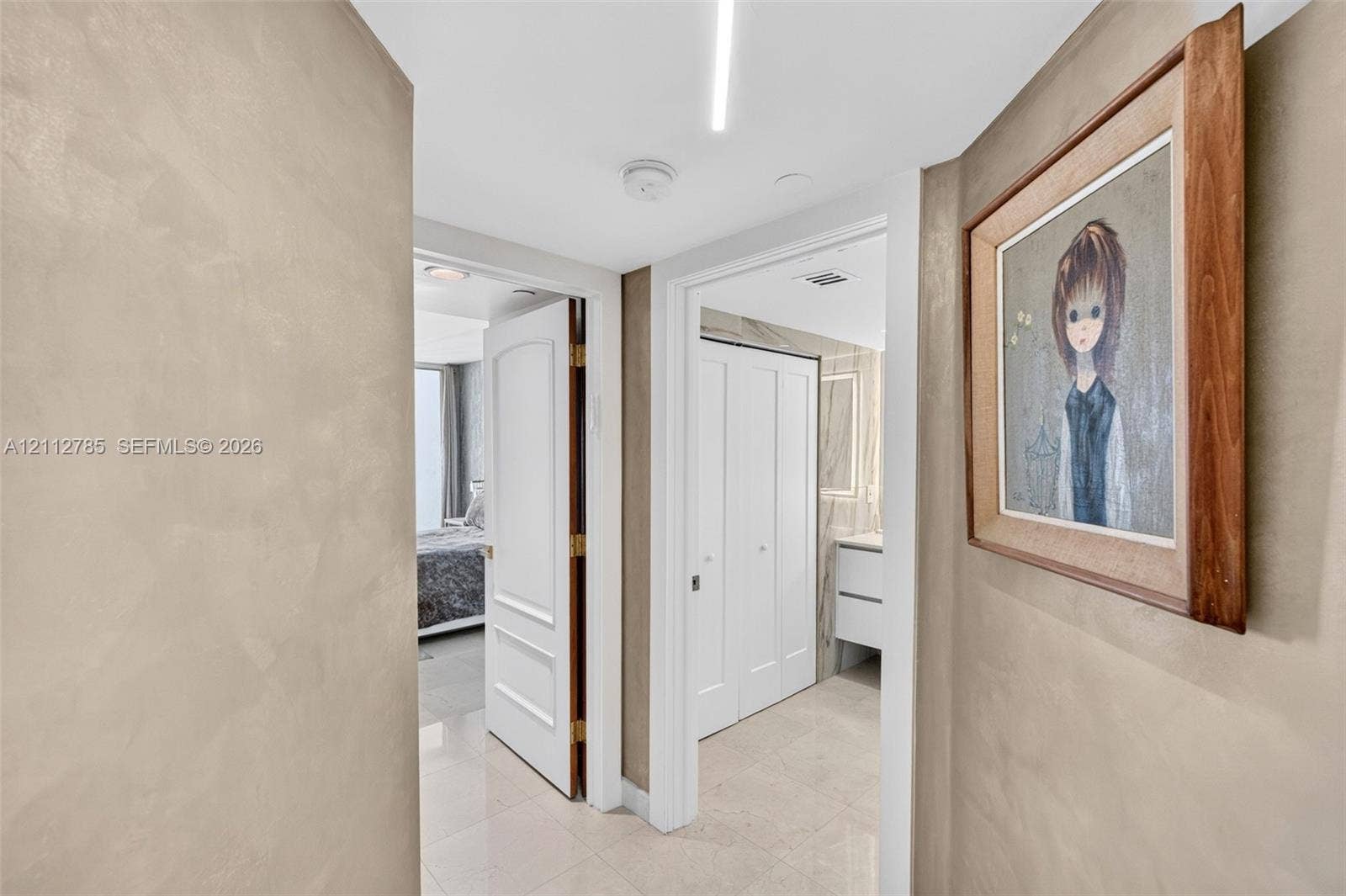 16425 Collins Avenue, #2016, Sunny Isles Beach, FL 33160 Textured wall finish, tile flooring, and solid core doors featuring recessed panels
