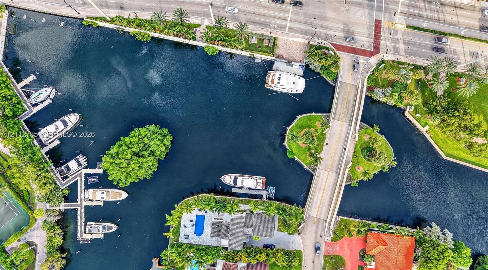 16425 Collins Avenue, #2016, Sunny Isles Beach, FL 33160 Waterfront property featuring a private boat dock, deep-water canal access, a paved deck, and a tennis court