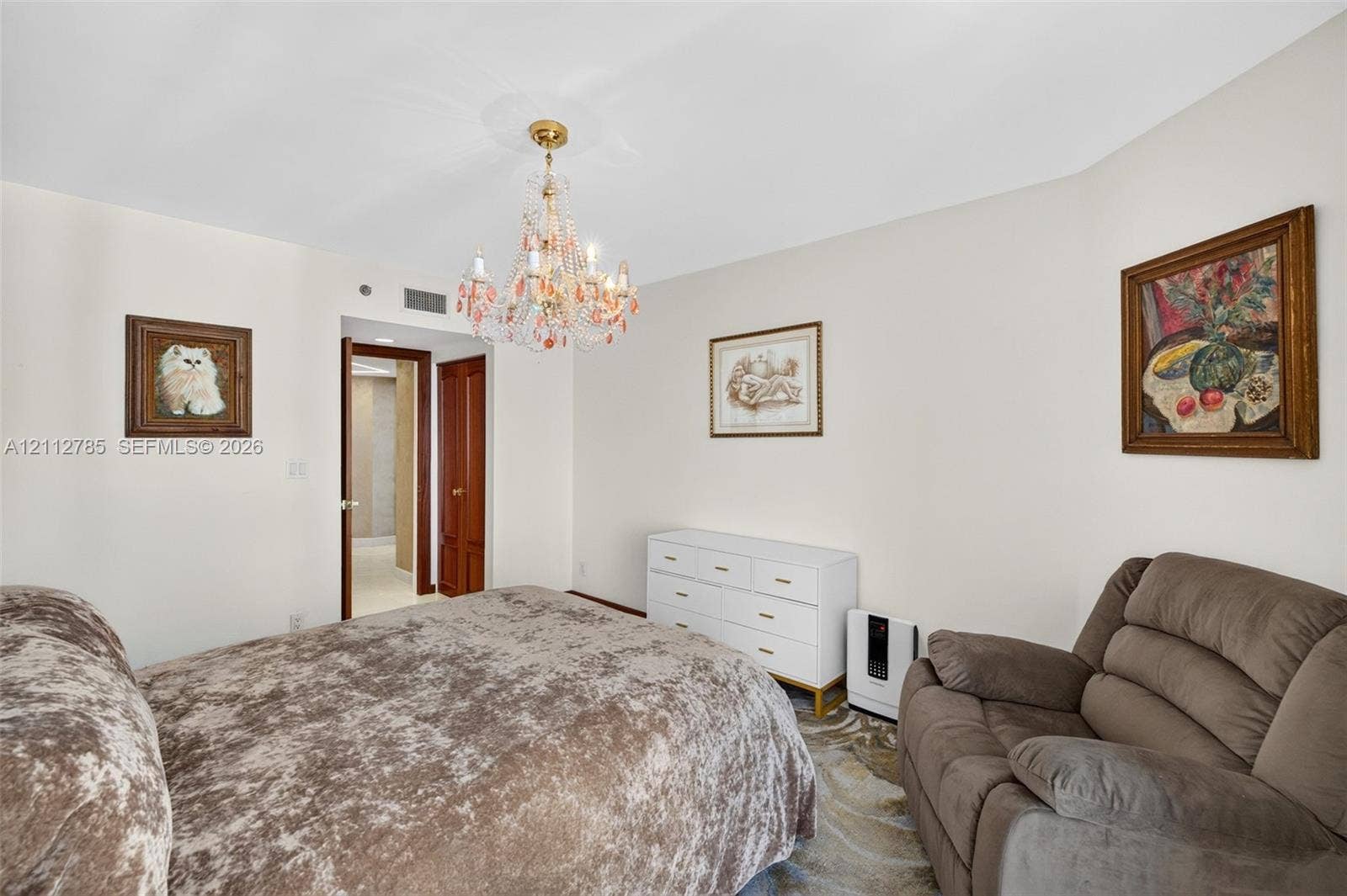16425 Collins Avenue, #2016, Sunny Isles Beach, FL 33160 Multi-faceted glass chandelier with gold-tone finish and solid wood interior doorway