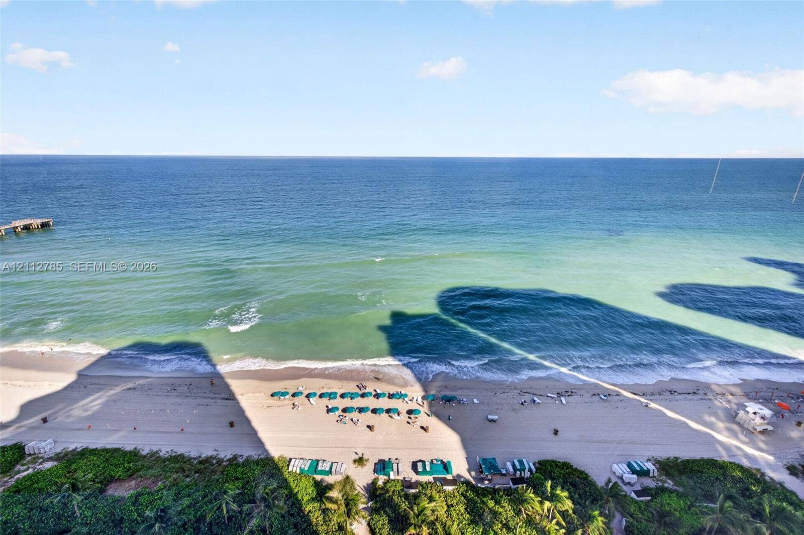 16425 Collins Avenue, #2016, Sunny Isles Beach, FL 33160 Direct oceanfront exposure featuring expansive sandy shoreline, turquoise water, and a wooden pier