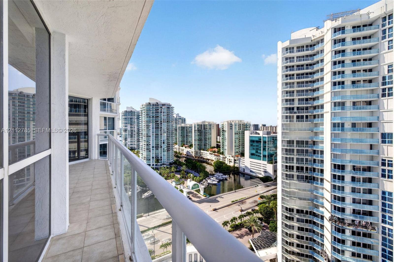 16425 Collins Avenue, #2016, Sunny Isles Beach, FL 33160 Covered balcony featuring tile flooring and a glass-paneled railing