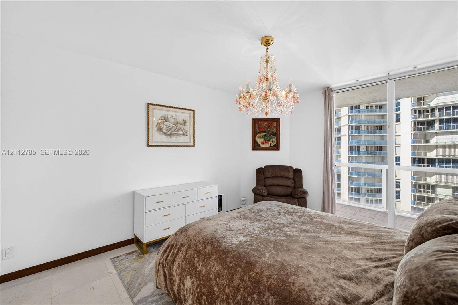 16425 Collins Avenue, #2016, Sunny Isles Beach, FL 33160 Floor-to-ceiling windows, crystal chandelier, and light-toned tile flooring