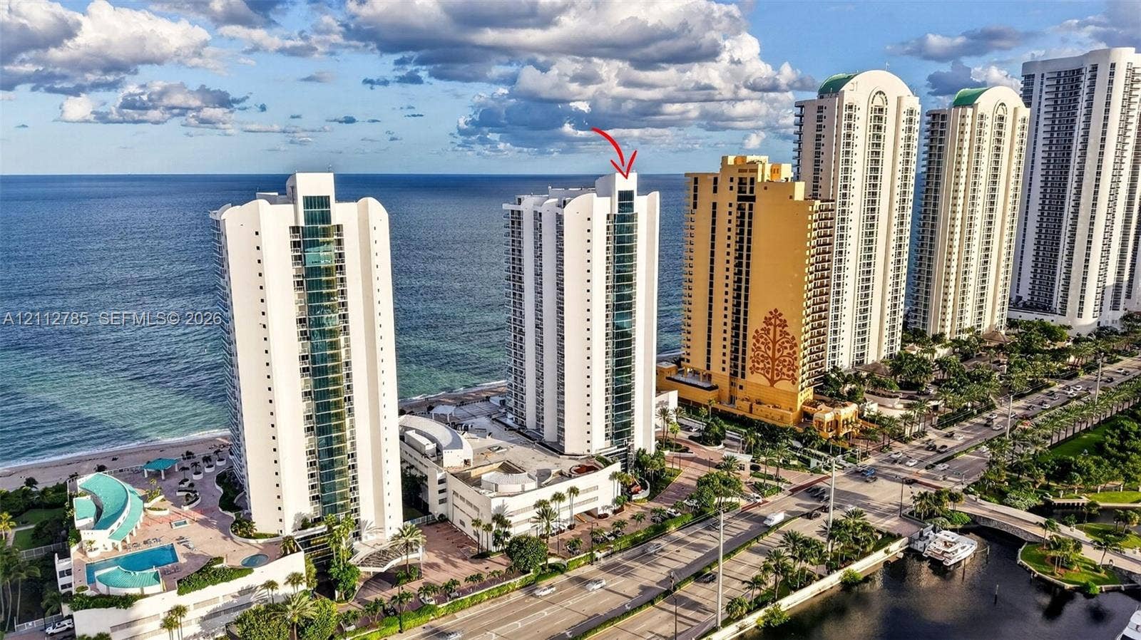16425 Collins Avenue, #2016, Sunny Isles Beach, FL 33160 High-rise coastal architecture featuring glass-paneled balconies and direct proximity to the oceanfront