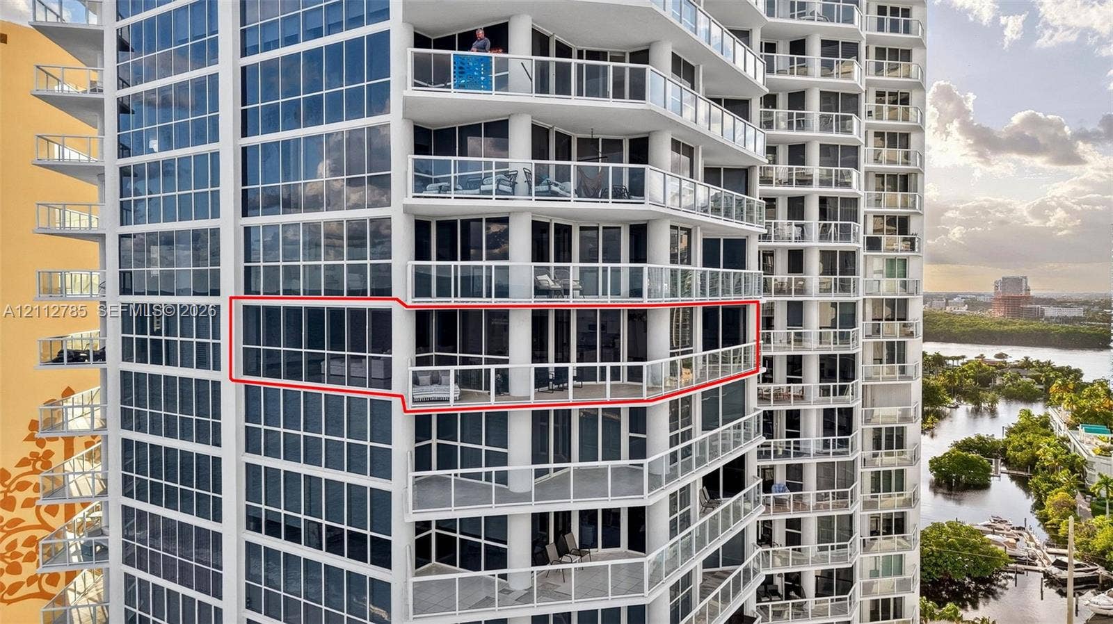 16425 Collins Avenue, #2016, Sunny Isles Beach, FL 33160 High-rise residential exterior featuring floor-to-ceiling glass paneling and a wraparound private balcony with a glass railing