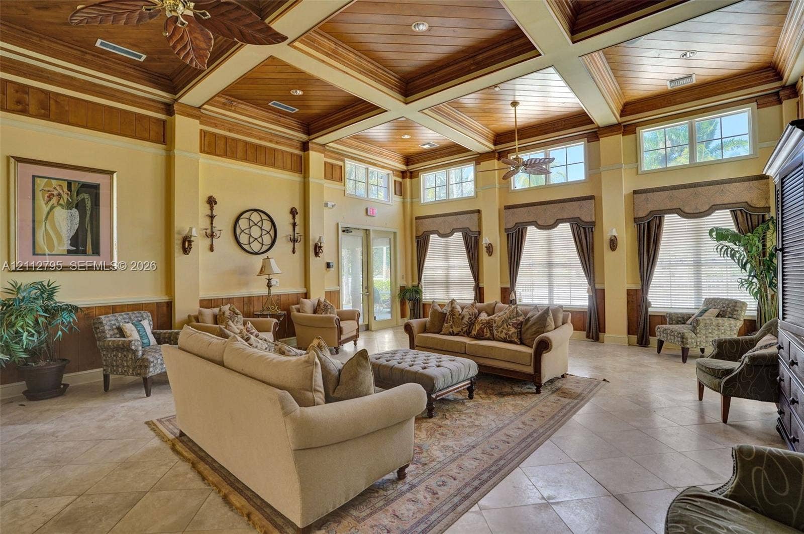 275 Murcia Drive, #205, Jupiter, FL 33458 Coffered ceiling with wood paneling, tile flooring, and oversized windows