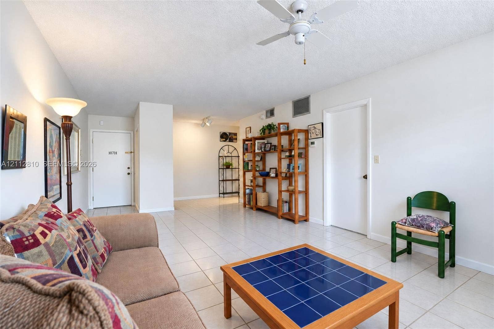 1920 NE 1st Terrace, #107H, Wilton Manors, FL 33305 Interior space featuring neutral wall tones, large-format tile flooring, a white ceiling fan, and track lighting