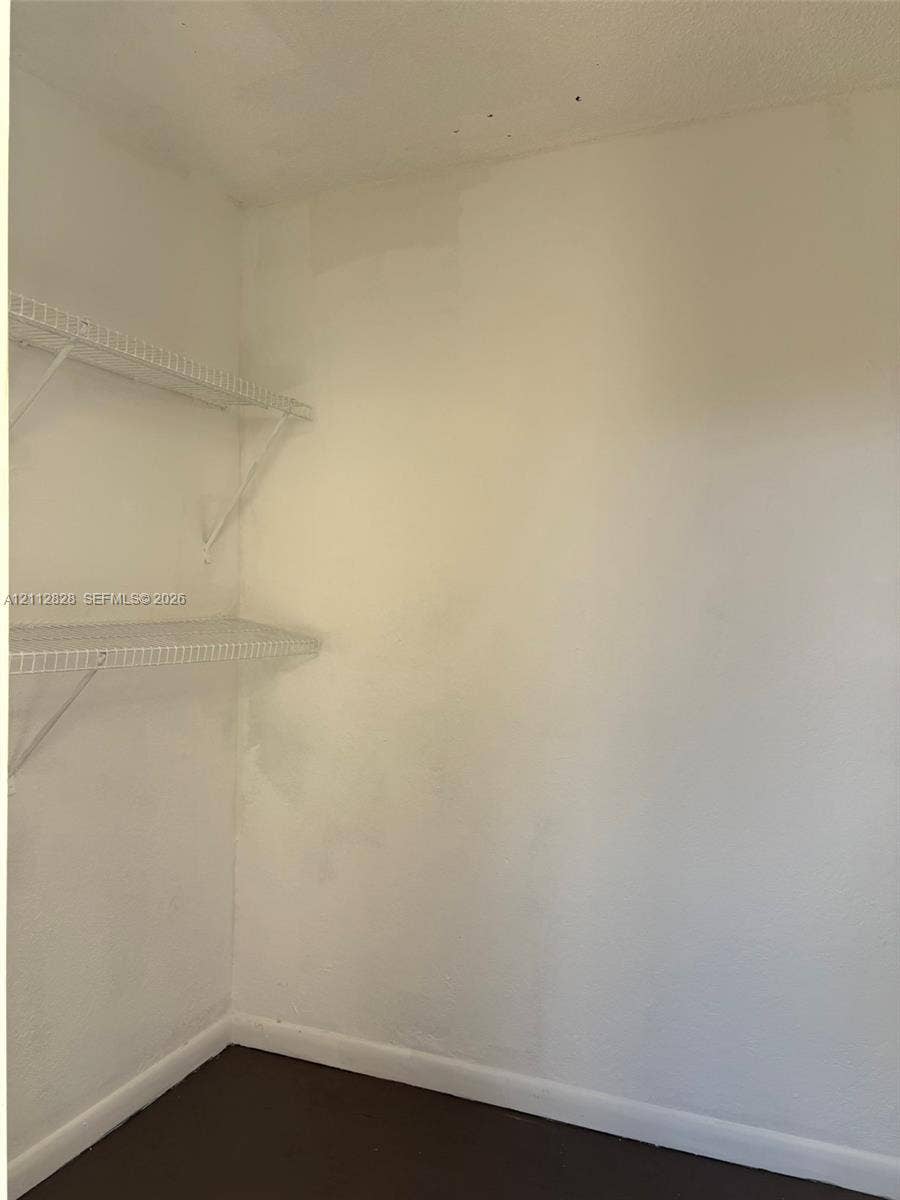 508 NW 43rd Place, Deerfield Beach, FL 33064 Storage space featuring dual-tier white wire shelving and dark flooring