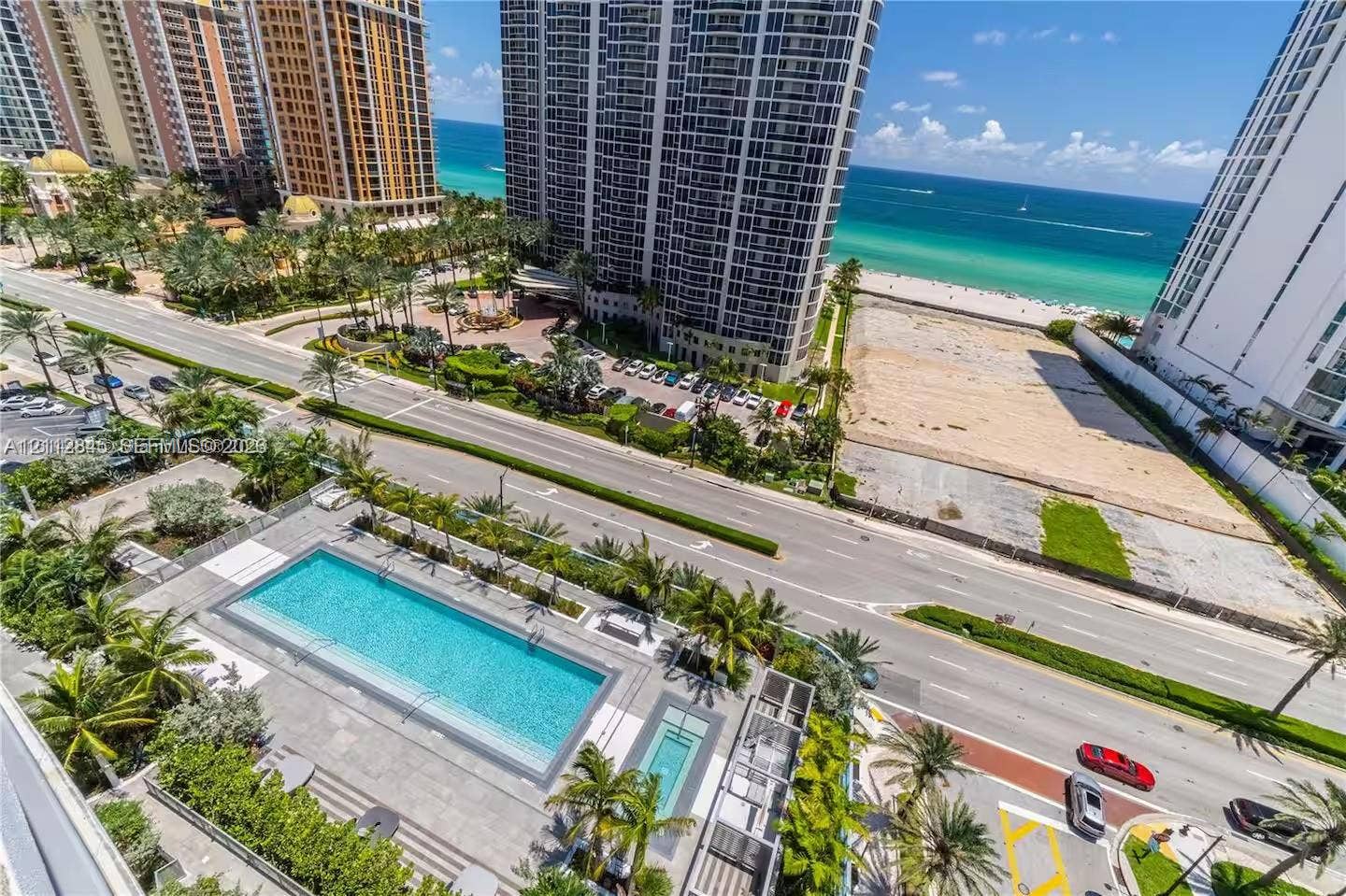 17550 Collins Avenue, #1202, Sunny Isles Beach, Sunny Isles Beach, FL 33160 Rectangular swimming pool with integrated spa, concrete deck, and palm tree landscaping