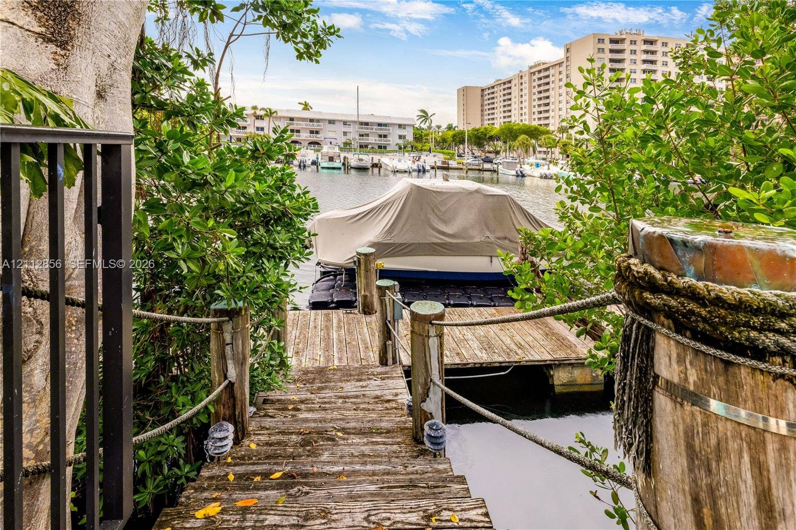 285 Las Brisas Court, Coral Gables, FL 33143 Private wooden dock featuring rope handrails, timber pilings, and direct water access
