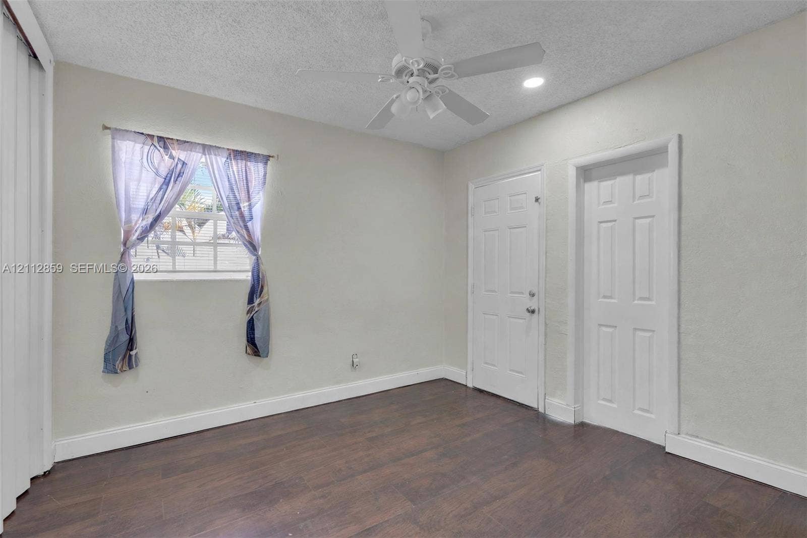1207 Chateau Park Drive, Fort Lauderdale, FL 33311 Room featuring wood-finish flooring, a ceiling fan with integrated lighting, recessed lighting, and two interior panel doors