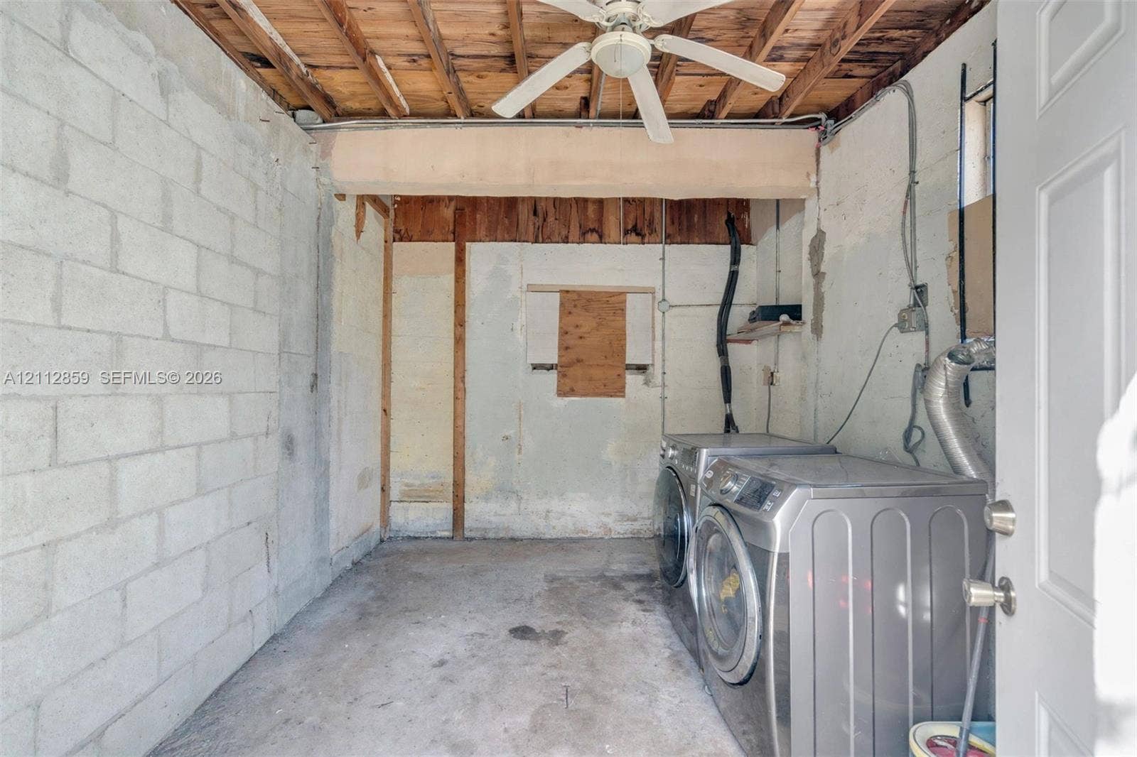 1207 Chateau Park Drive, Fort Lauderdale, FL 33311 Utility space with exposed wood joist ceiling, concrete block walls, concrete flooring, and ceiling-mounted fan