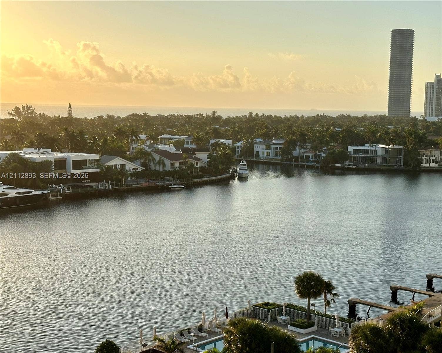 20515 E Country Club Drive, #1048, Aventura, FL 33180 Waterfront panorama featuring a canal-side swimming pool, multi-level docks, and a backdrop of coastal skyline