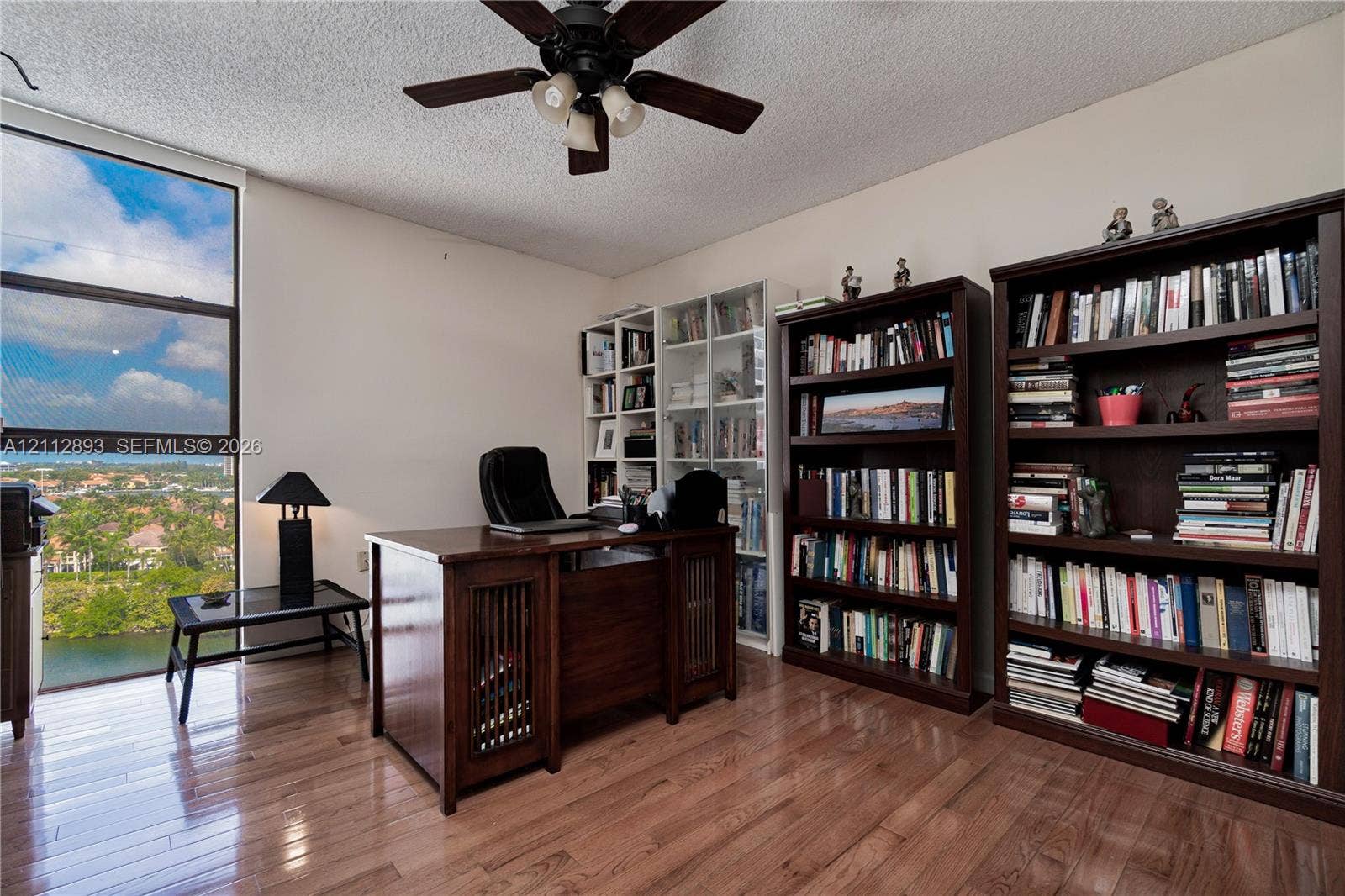20515 E Country Club Drive, #1048, Aventura, FL 33180 Floor-to-ceiling window featuring natural light, wood-finish flooring, and an attached ceiling fan with lighting