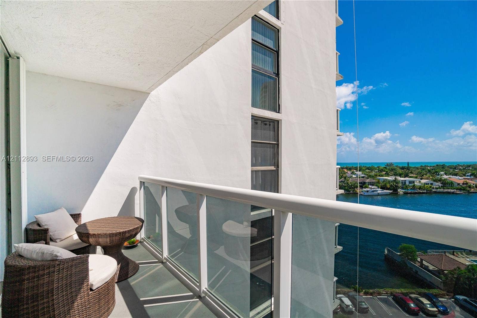 20515 E Country Club Drive, #1048, Aventura, FL 33180 Covered balcony featuring a glass and aluminum railing, concrete flooring, and water frontage