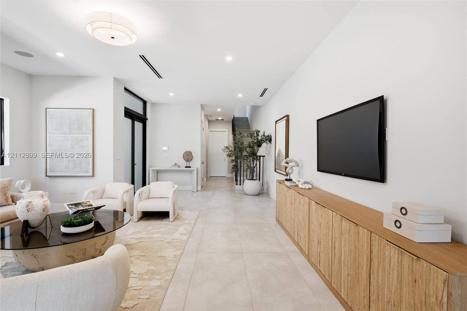 2747 SW 23rd Terrace, Miami, FL 33145 Large-format tile flooring, built-in wooden cabinetry, recessed lighting, and a multi-tiered drum light fixture