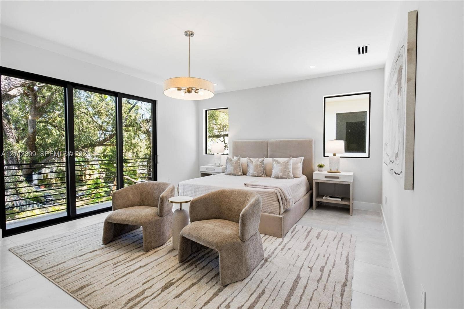 2747 SW 23rd Terrace, Miami, FL 33145 Large format sliding glass doors, polished stone flooring, drum pendant lighting, and oversized windows