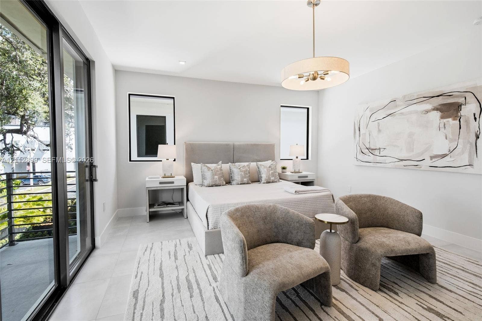 2747 SW 23rd Terrace, Miami, FL 33145 Neutral-toned room featuring large-format tile flooring, sliding glass door access to a balcony, recessed lighting, and a drum-style pendant fixture