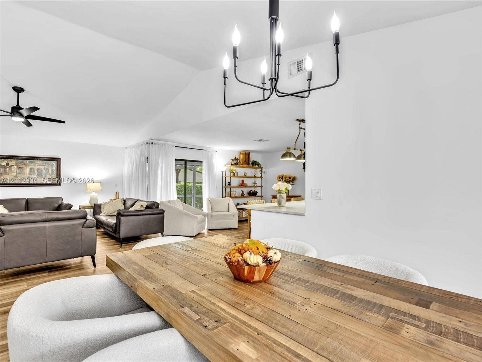 76 Forest Circle, Cooper City, FL 33026 Vaulted ceilings, matte black metal chandelier, ceiling fan, and wood-finish flooring
