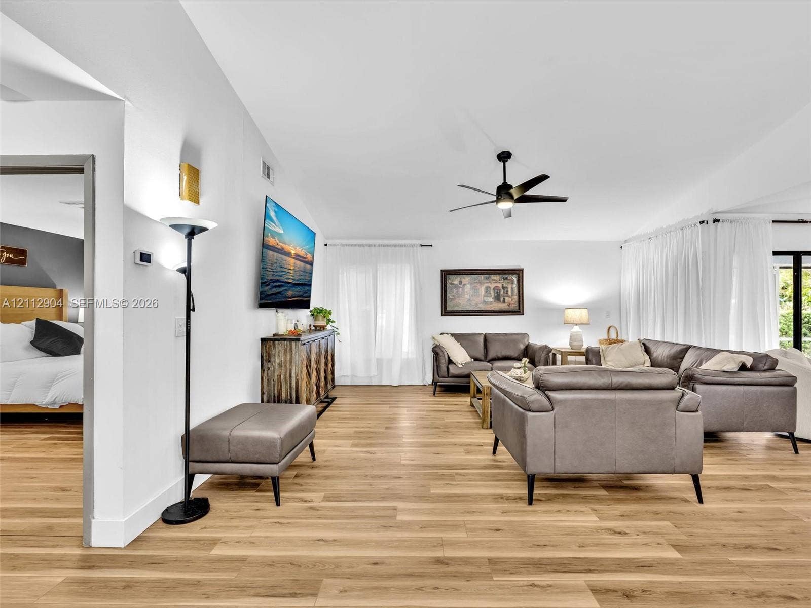 76 Forest Circle, Cooper City, FL 33026 Living space featuring wood-finish flooring, high ceilings, and a multi-blade ceiling fan