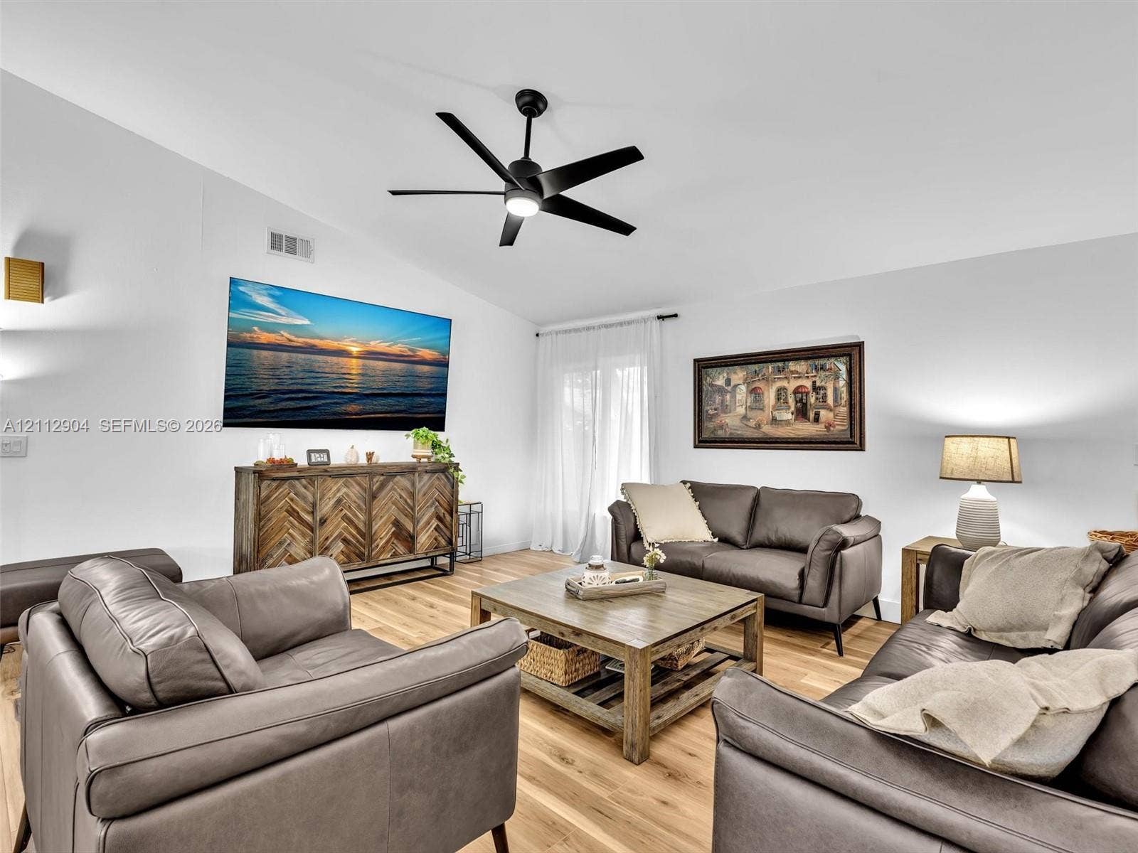 76 Forest Circle, Cooper City, FL 33026 Vaulted ceilings, wood-finish flooring, and a contemporary matte black ceiling fan with integrated lighting