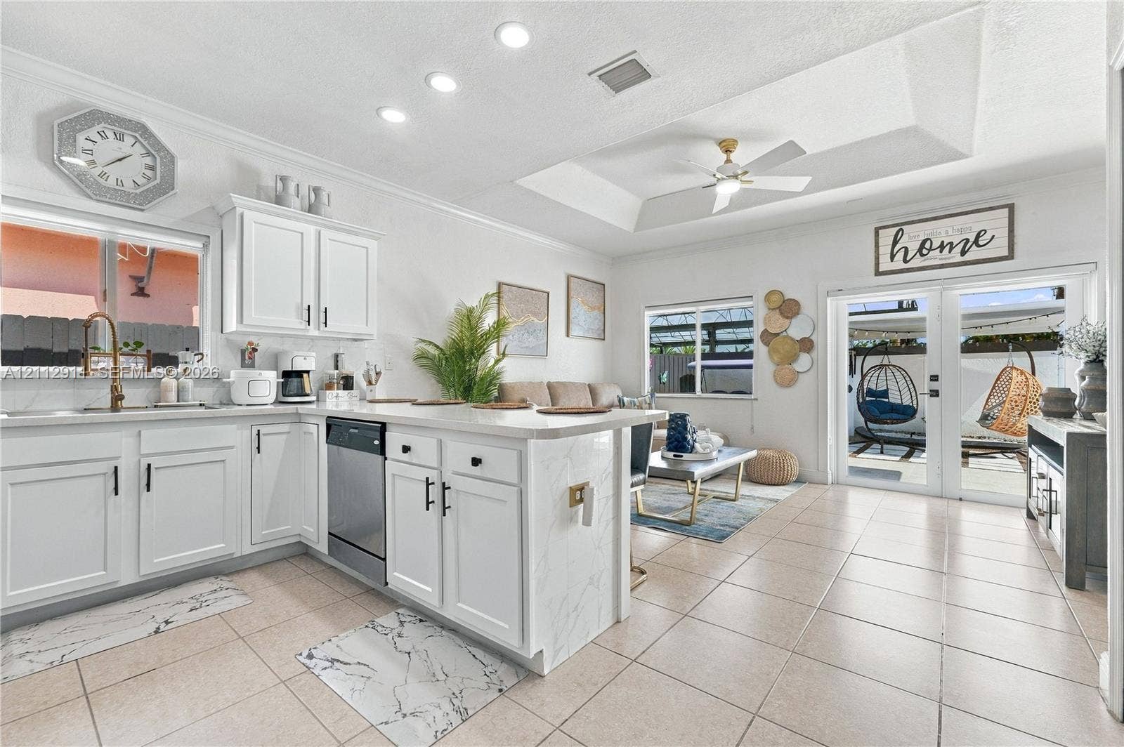 217 SW 15th Place, Homestead, FL 33030 Kitchen featuring white shaker-style cabinetry, stone-finish countertops, stainless steel appliances, recessed ceiling lighting, and tile flooring