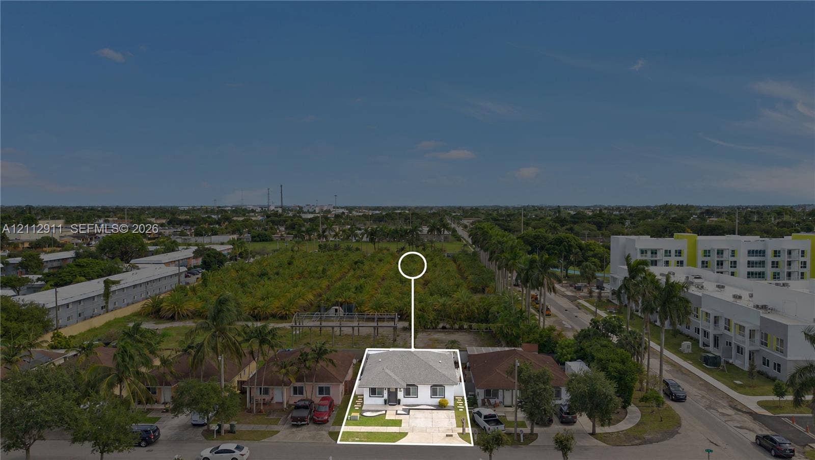 217 SW 15th Place, Homestead, FL 33030 Single-story residence featuring a hip roof, concrete driveway, and front lawn