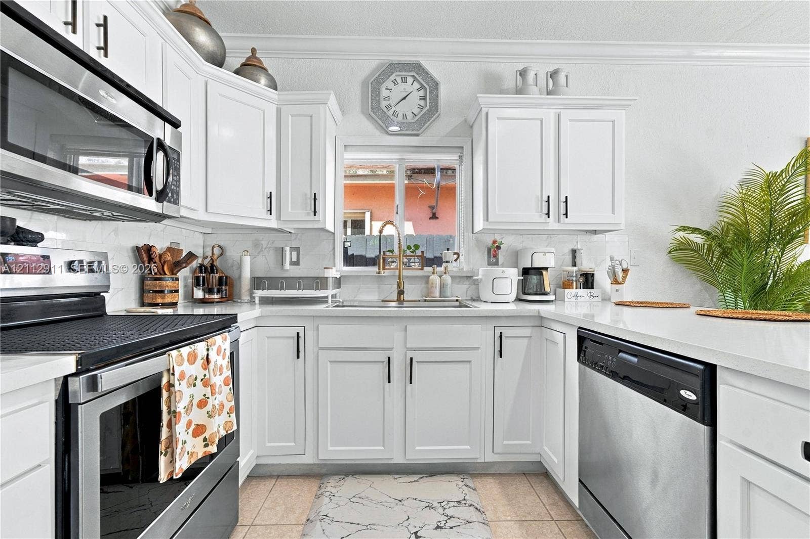 217 SW 15th Place, Homestead, FL 33030 Kitchen featuring white cabinetry with matte black hardware, stone-finish countertops, stainless steel appliances, and a single-basin sink with a goose-neck faucet