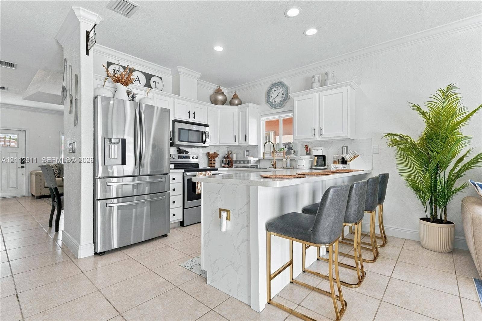 217 SW 15th Place, Homestead, FL 33030 Kitchen featuring white cabinetry, stone-finish waterfall edge island, tile flooring, recessed lighting, and stainless steel appliances
