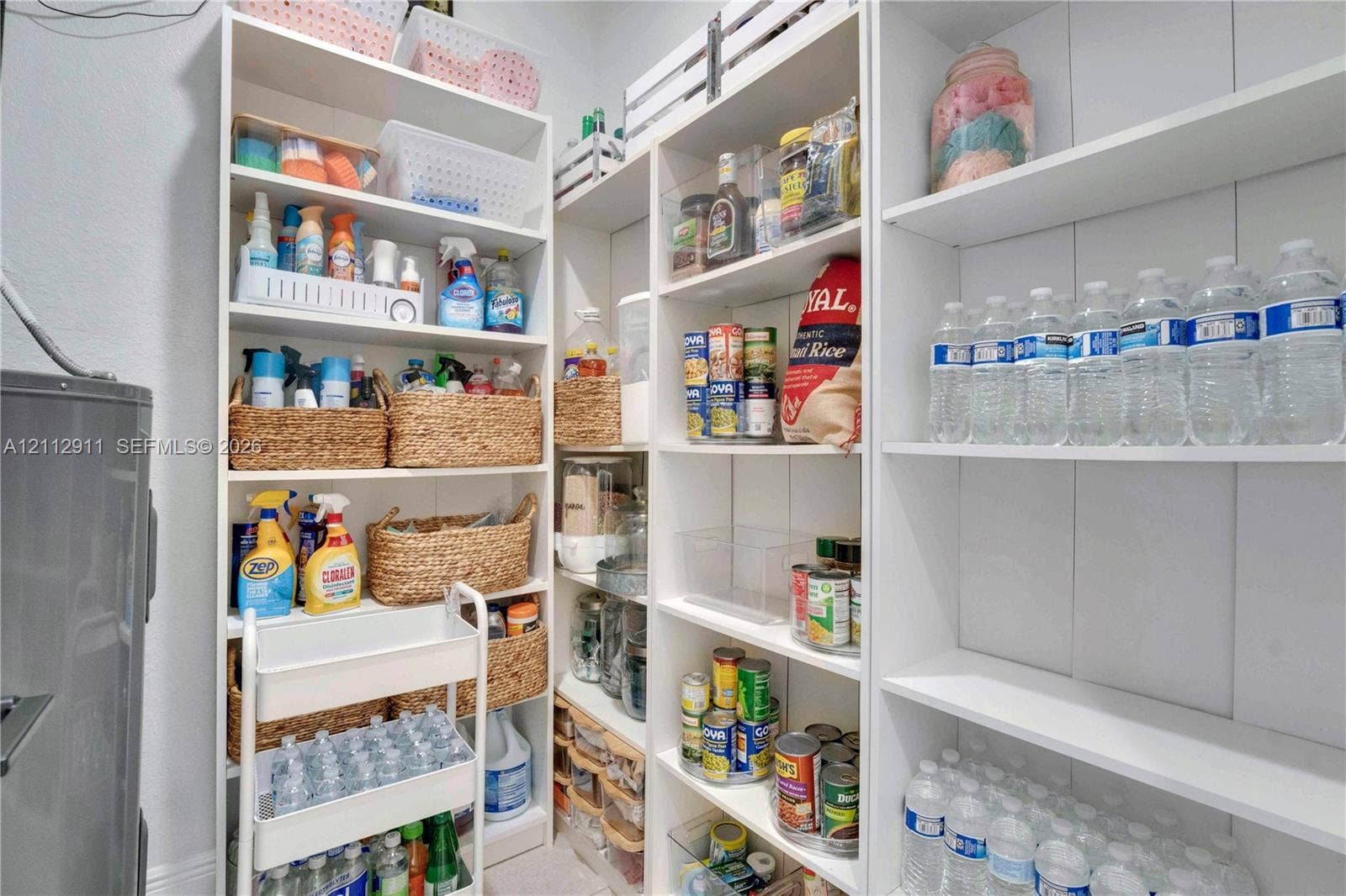 217 SW 15th Place, Homestead, FL 33030 Built-in white floor-to-ceiling cabinetry with multi-level adjustable shelving and vertical plank-style wall paneling