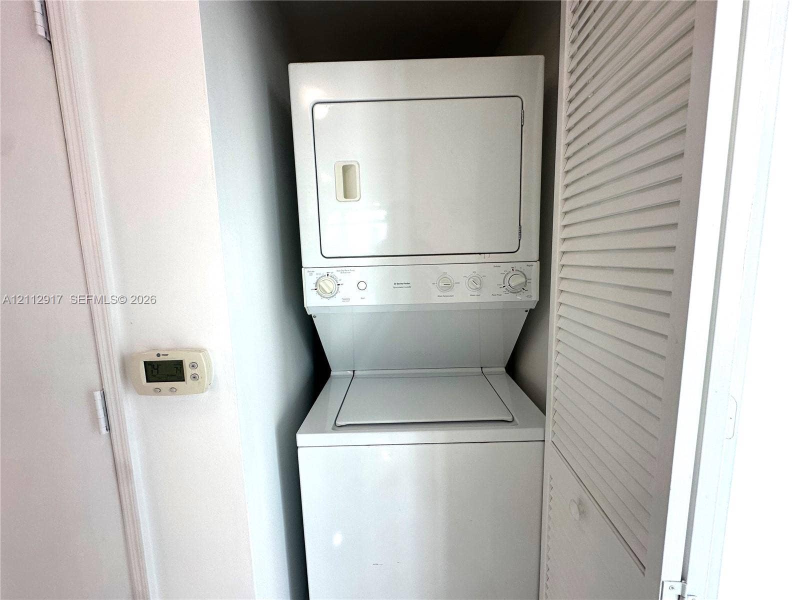 951 Brickell Avenue, #2601, Miami, Miami, FL 33131 Stacked washer and dryer unit with louvered closet door access