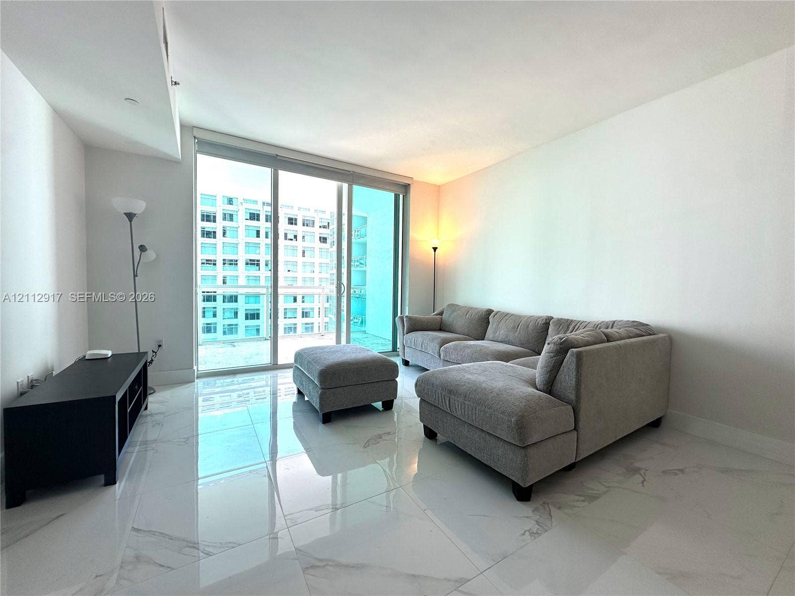 951 Brickell Avenue, #2601, Miami, Miami, FL 33131 Large-format polished stone flooring with white and grey veining, floor-to-ceiling glass sliding doors, and private balcony access