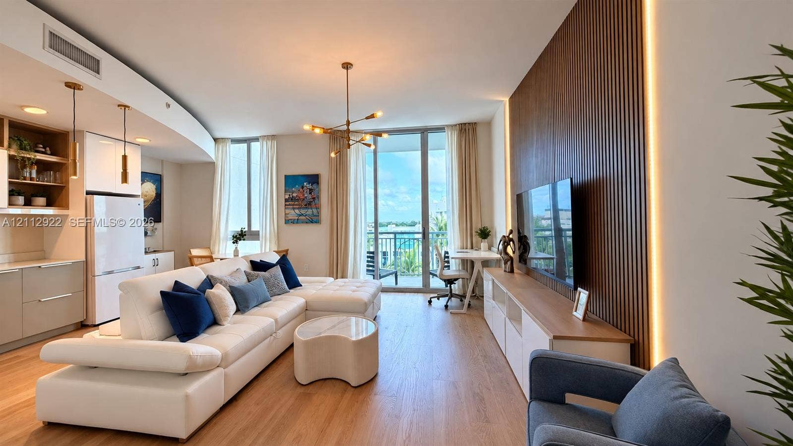 Open-concept interior featuring wood-finish flooring, a wood-slat accent wall with integrated LED lighting, and floor-to-ceiling glass doors