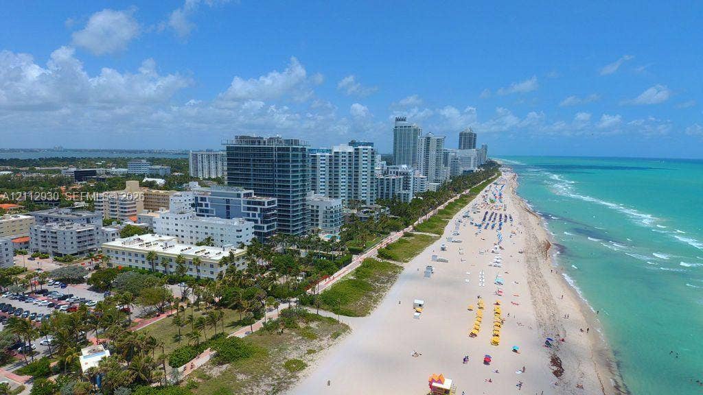 3030 Collins Avenue, #1G, Miami Beach, FL 33140 Aerial perspective showcasing immediate proximity to the Atlantic Ocean coastline, expansive sandy beaches, and high-density urban infrastructure