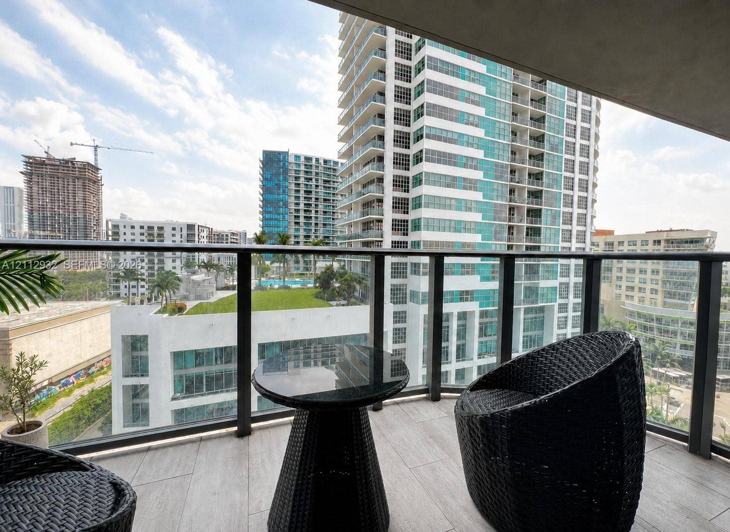 121 NE 34th Street, #903, Miami, FL 33137 Private balcony featuring tile flooring and a glass-paneled railing