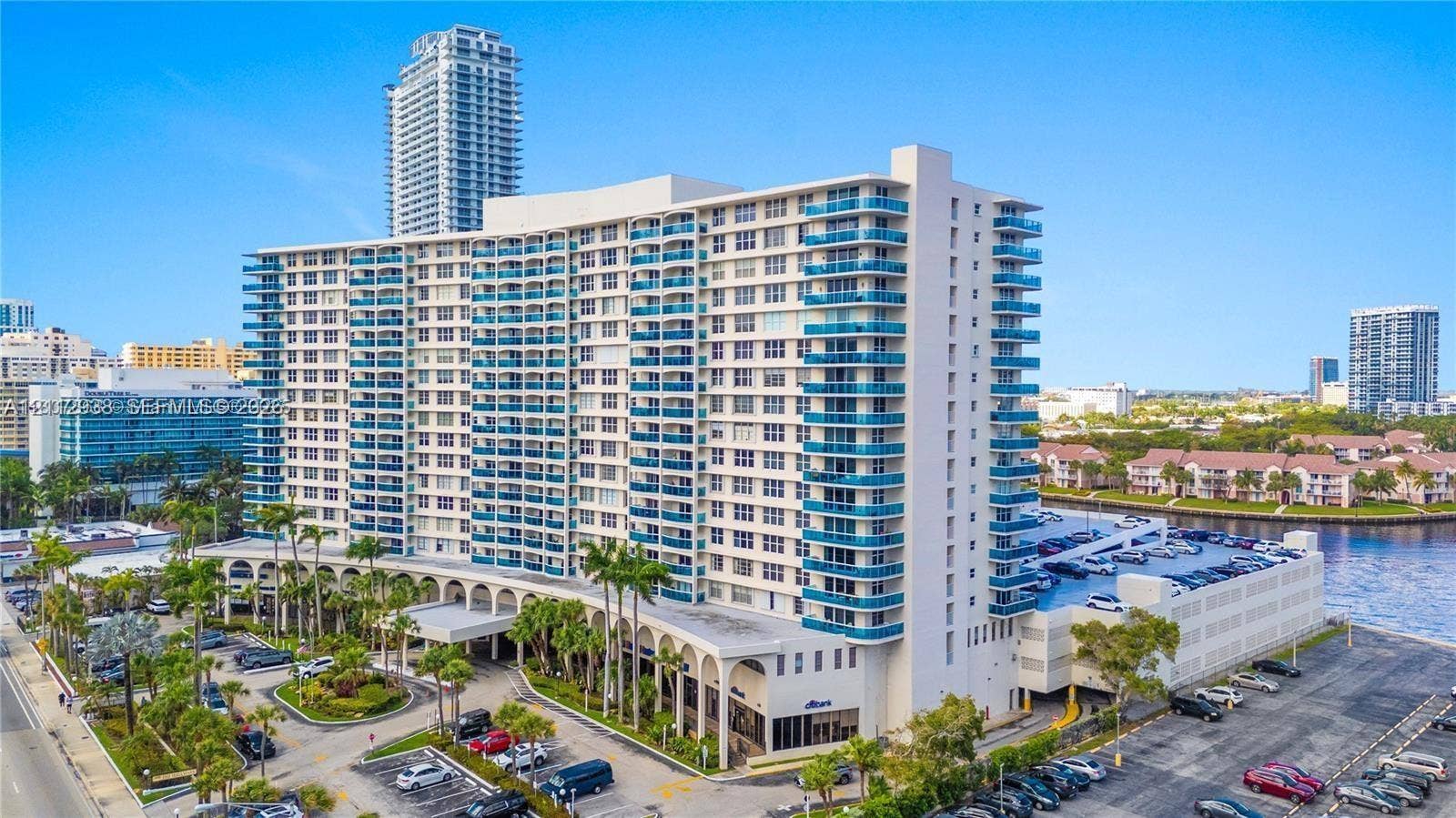 3800 S Ocean Drive, #801, Hollywood, FL 33019 High-rise residential building featuring stacked balconies, exterior archways, on-site parking, and water frontage