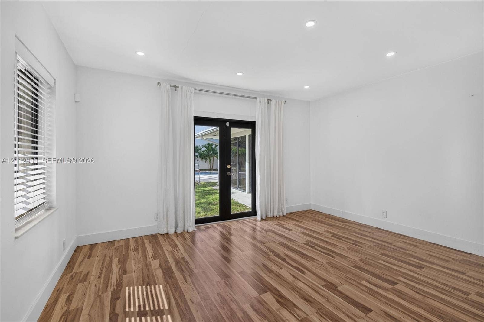 549 NE 12th Avenue, Fort Lauderdale, FL 33301 Wood-finish flooring, recessed lighting, and black-framed glass French doors
