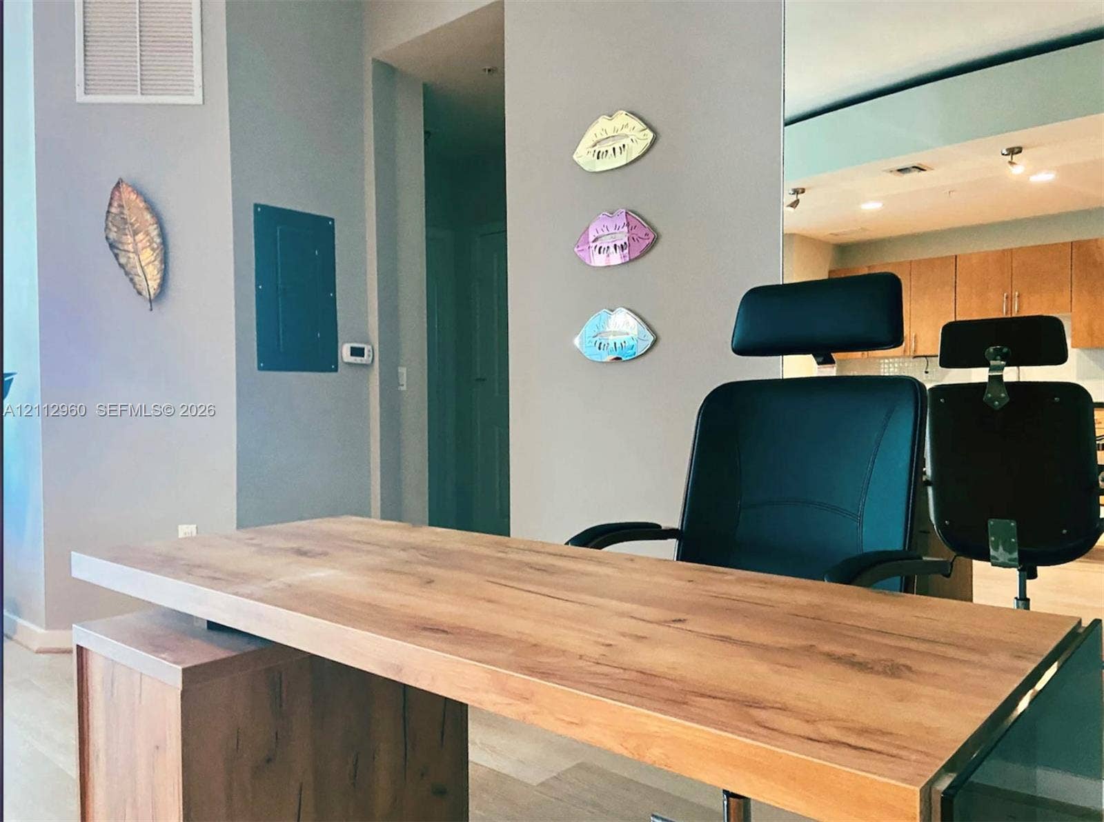 Neutral-toned interior featuring wood-finish flooring and recessed ceiling lighting