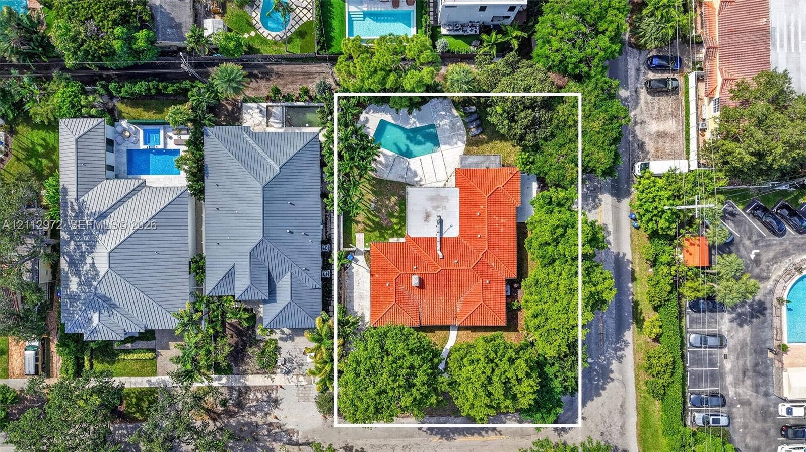 549 NE 12th Avenue, #0, Fort Lauderdale, Fort Lauderdale, FL 33301 Aerial perspective featuring a terracotta tile roof, private swimming pool, concrete patio, and mature tree canopy on the parcel