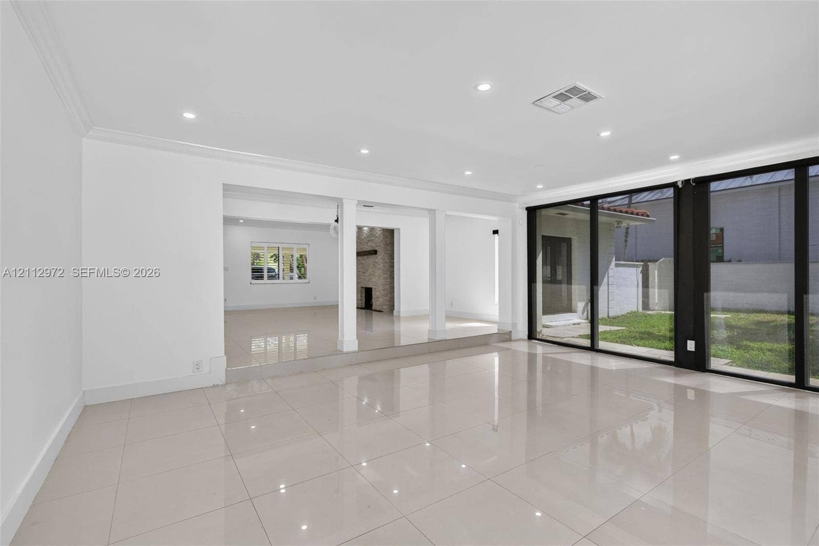 549 NE 12th Avenue, #0, Fort Lauderdale, Fort Lauderdale, FL 33301 Polished tile flooring, recessed lighting, expansive sliding glass doors, and structural pillars featuring a raised elevation