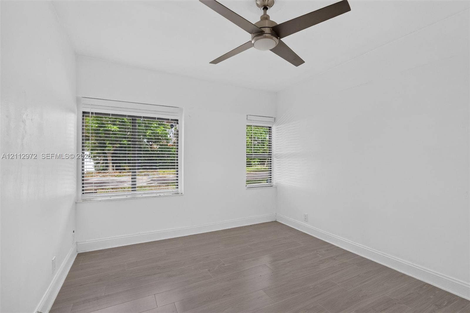549 NE 12th Avenue, #0, Fort Lauderdale, Fort Lauderdale, FL 33301 Room featuring wood-finish flooring, a matte-finish ceiling fan, and horizontal window blinds