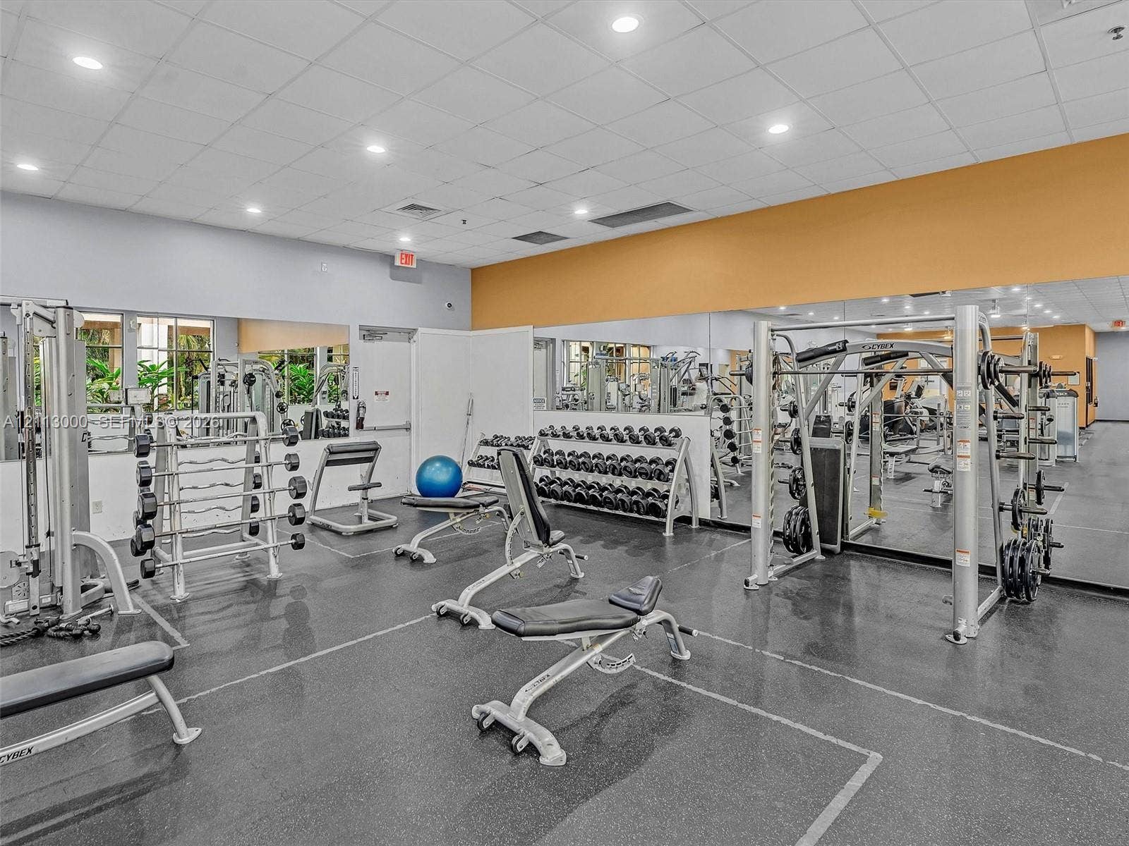 10860 La Salinas Circle, Boca Raton, FL 33428 Fitness center featuring wall-to-wall mirrors, durable rubberized flooring, and recessed ceiling lighting